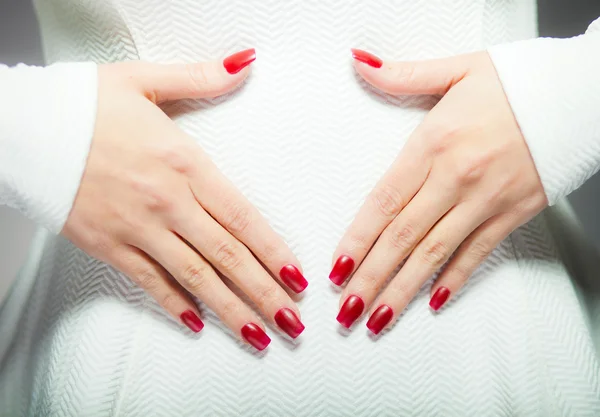 Frau zeigt ihre roten Nägel, Maniküre — Stockfoto