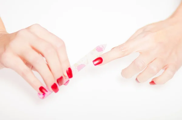 Girl hand manicure with nail file on bright background — Stock Photo, Image