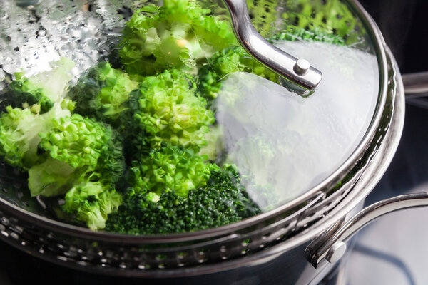 Freshly steamed green broccoli in skimmer pot