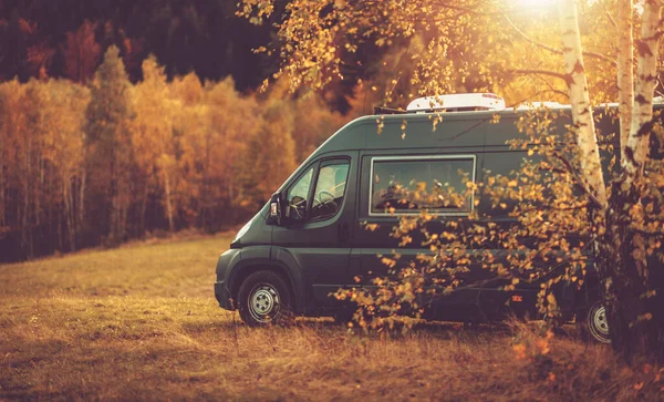 Autumn Fall Foliage RV Recreational Vehicle Camper Van Road Trip and Scenic Camping in Beautiful Place. Motorhome and the Scenic Nature. Travel Theme.