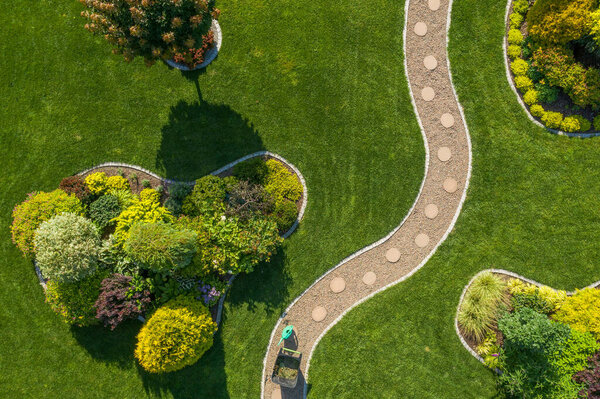 Mature Residential Backyard Garden with Large Grass Lawn Aerial Top View. Gardening and Landscaping Industry Theme. Summer Time.