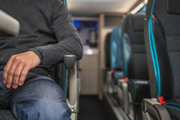 Caucasian Passenger in His 40s Seating Inside Comfortable Coach Bus Close Up. Public Transportation Theme. Automotive Industry.