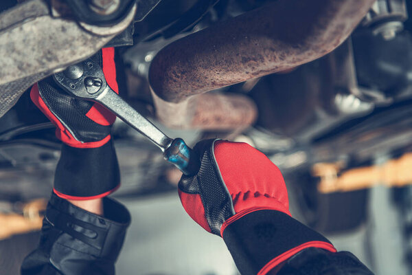 Auto Service Car Mechanic Repairing Modern Car Suspension Element Close Up. Automotive Industry. Broken Vehicle Theme.