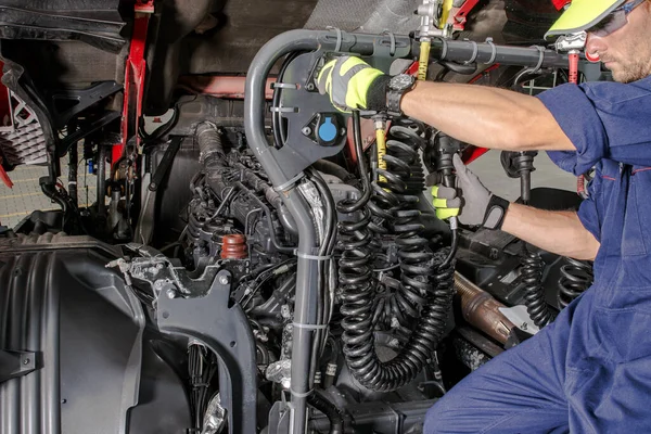 Caucasian Semi Truck Mechanic Performing Diesel Engine Maintenance Scheduled Checkup — стокове фото