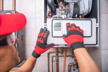 40 'larında Kafkasyalı HVAC teknisyeni tarafından yapılan gaz ısıtıcısı tamiri. Modern Isıtma Teknolojileri.