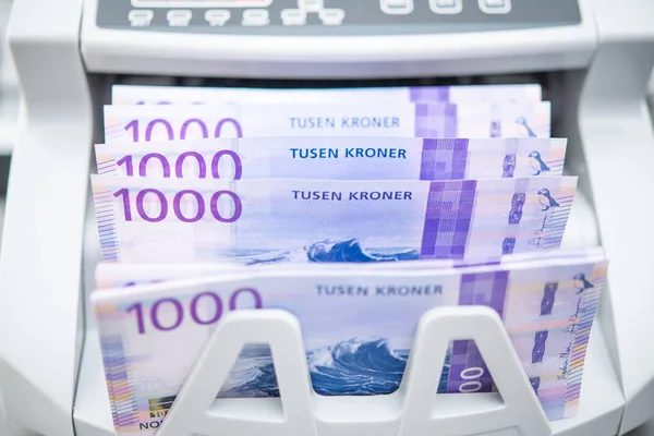 Norwegian Kroner Banknotes Inside Bank Branch Bill Counter. One Thousand Kroner Bills. Scandinavian Business Theme.