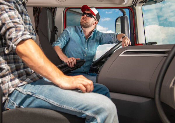 Two Caucasian Truckers International Haul Team. Semi Truck Drivers Preparing For Another Long Haul Trip.