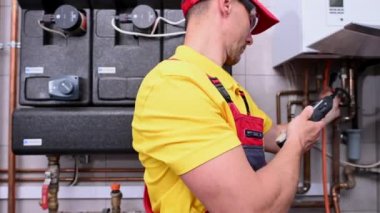 June 1, 2021. Krakow, Lesser Poland. Caucasian Worker in His 40s Looking For Gas Leaks Using Professional Detector. HVAC Theme