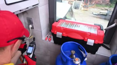 June 1, 2021. Krakow, Lesser Poland. Professional Technician Repair Gas Heater. Central Home Heating System.