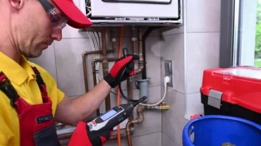 HVAC Technician with Gas Leak Detector in His Hands Checking on Levels