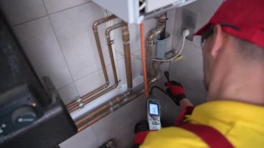 June 1, 2021. Krakow, Lesser Poland. Heating System Final Adjustment Performed by Technician. Pipelines, Valves and Counters of Residential Heating System. Industrial Theme.