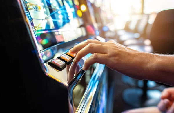 stock image Woman Playing Classic Slot Machine Inside Las Vegas Casino. One Handed Bandit Game Play. Gambling Industry Theme.