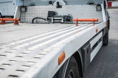 Bir kamyon yatağı işlek bir caddede araçların yüklenmesini bekliyor..