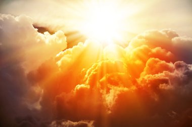 bright rays of the sun and clouds