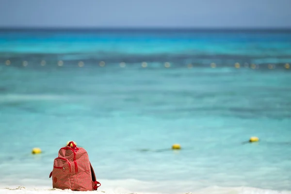 Red bag on the beach — Stock Photo, Image