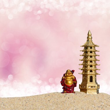 Laughing Buddha and seven-storied pagoda in the sand. Symbol of good luck and prosperity in Feng-Shui clipart