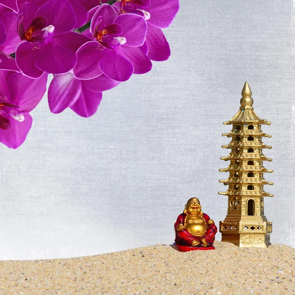 Buddha,orchid flowers and seven-storied pagoda in the sand. Symbol of good luck and prosperity in Feng-Shui — Stock Photo, Image