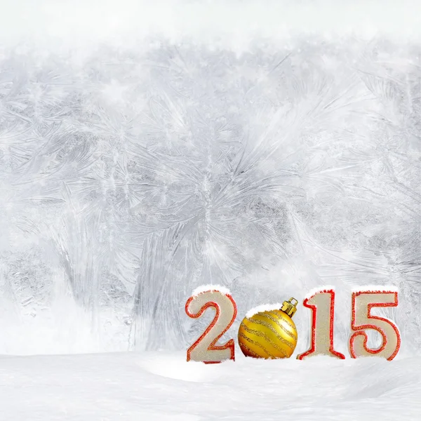 Christmas background - New year 2015 sign with snowdrift and frost patterns on window — Stock Photo, Image