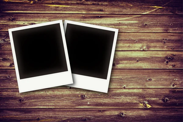 Photo frames on vintage wooden board background texture — Stock Photo, Image