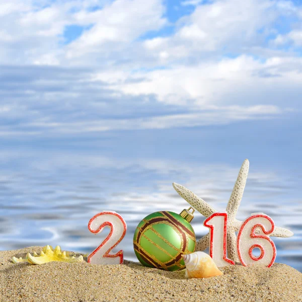 Lo sfondo di Natale con Anno nuovo il 2016 firma su una sabbia di spiaggia — Foto Stock