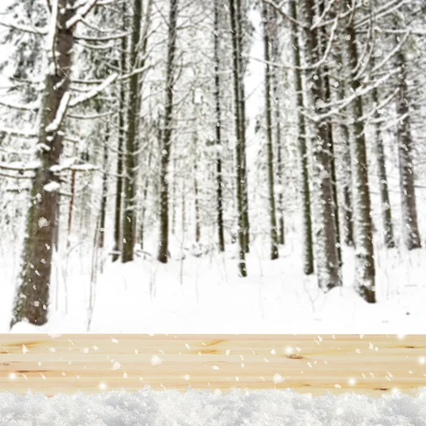 Sfondo sfocato invernale con foresta innevata e tavolo squallido — Foto Stock
