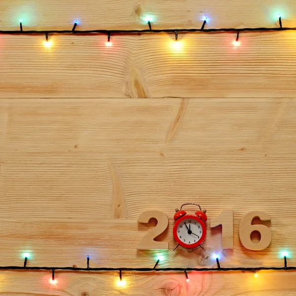 Kerstmis achtergrond met lampjes op de tabel — Stockfoto