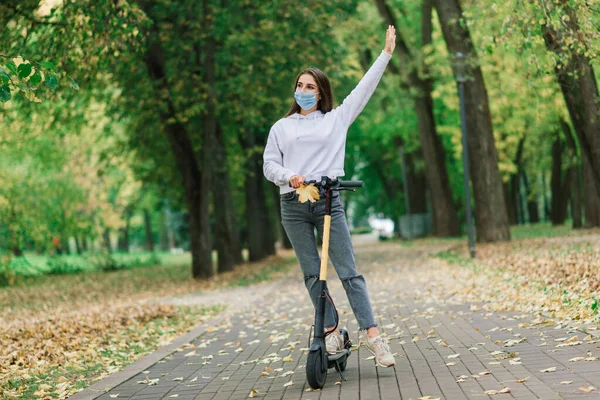 Mulher Caucasiana Casual Usando Máscara Protetora Montando Scooter Elétrico Urbano — Fotografia de Stock