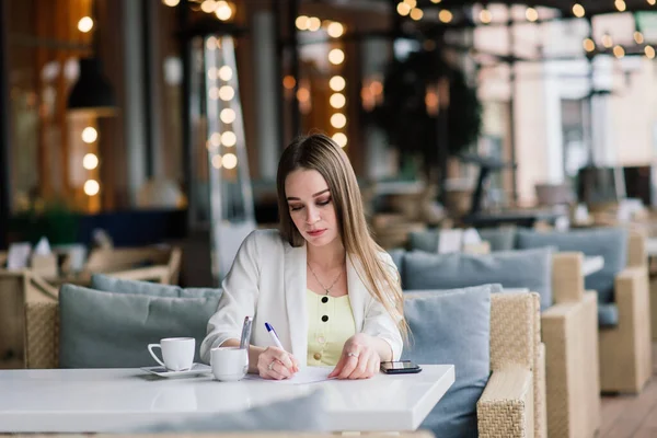 Jonge Vrouw Een Witte Jas Werken Cafe Met Kranten Het — Stockfoto