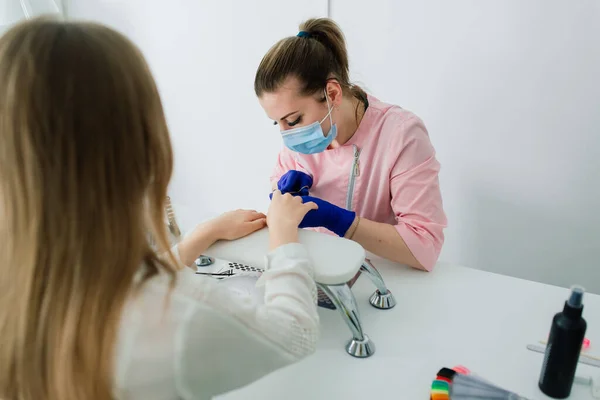 stock image Female manicure master in beauty salon work with hands of the client