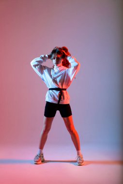 Stüdyoda poz veren genç ve güzel bir dansçı.