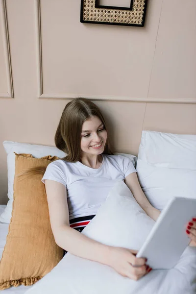 A young woman works in the home office manager or freelancer at work. Distance education. Student woman studying in her room. Online shopping, home work, freelance and online learning concept
