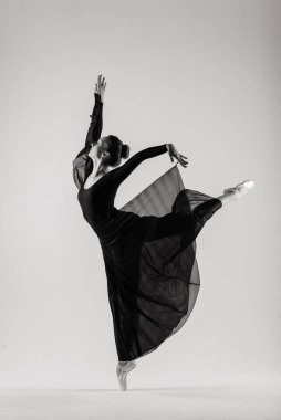 Beyaz takım elbiseli beyaz tenli beyaz dansçı portariti ve beyaz zeminde poz veren ayakkabılar..