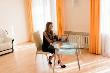 Dizüstü bilgisayar kullanan genç profesyonel kadın yöneticinin yakın plan görüntüsü. Taşınabilir bilgisayarla evden çalışan iş kadını.