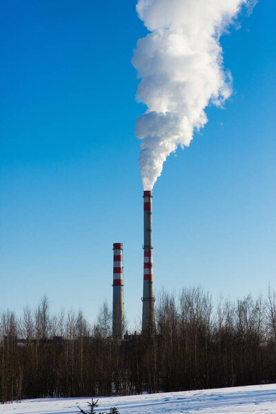 Industrial landscape, cranes, pipes with smoke. Air pollution from smokestacks, ecological problems concept