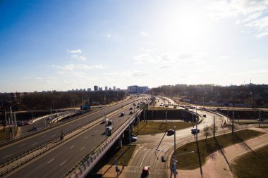 Aerial view at junctions of city highway. Vehicles drive on roads. Belarus, Russia clipart