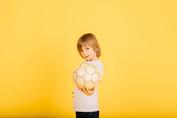 Retrato Menino Segurando Bola Futebol Estúdio Fundo Amarelo — Fotografia de Stock