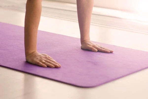 Young woman meditating, doing yoga at home, back, front and side view