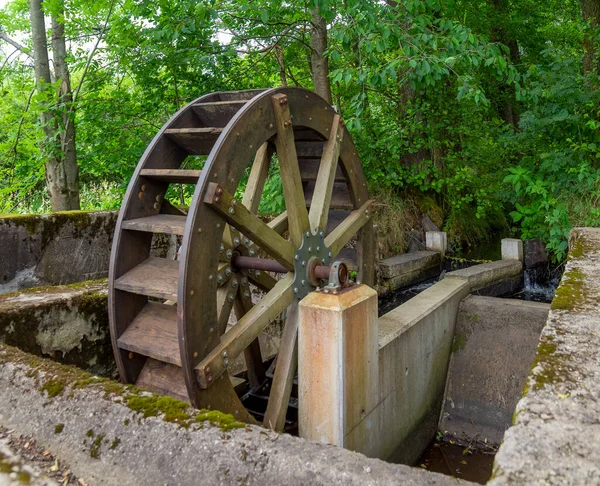 old rundown water wheel seen in the Bavarian Forest at summer time