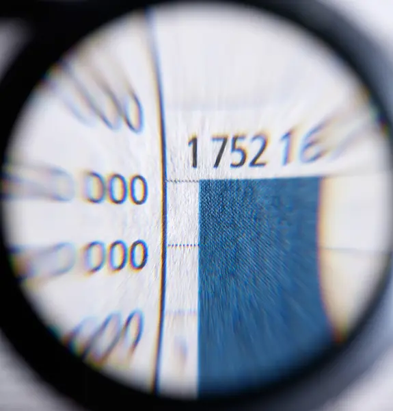 A magnifying glass and print detail — Stock Photo, Image