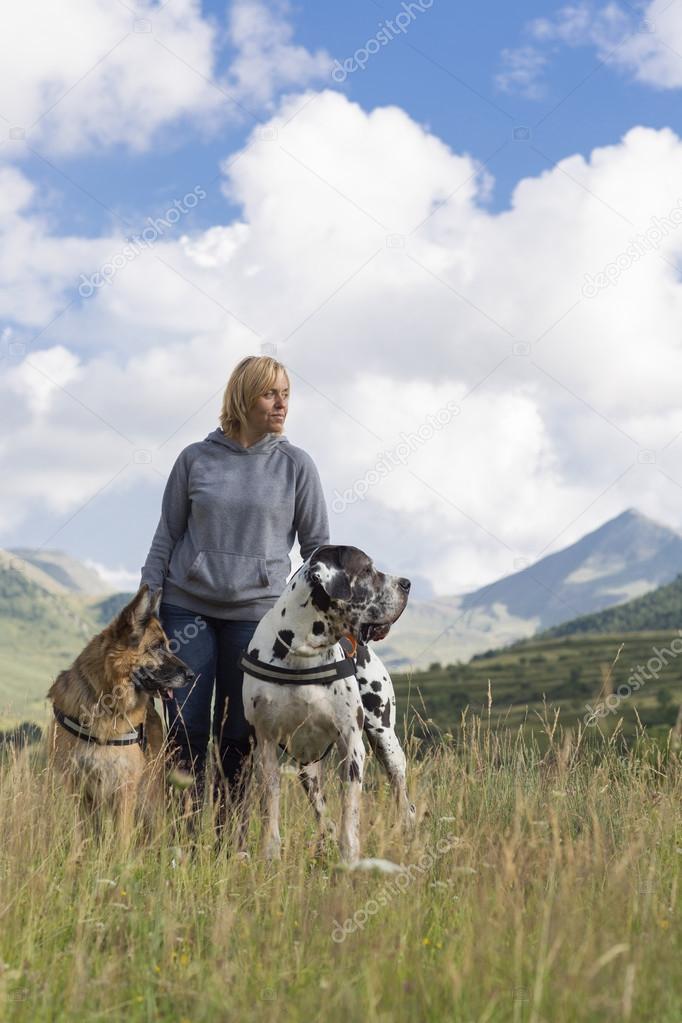 Woman, german sheperd and great dane