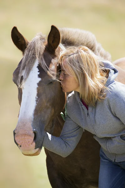 Woman long hair kissing beautiful horse — Stock Photo, Image