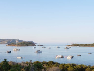 beach Capo Coda Cavallo with yachts moored in the sea