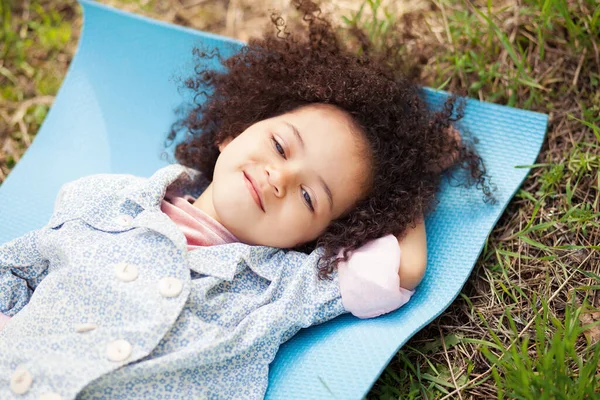 Cute Little Girl Lying Ground Resting Outdoors Stock Image