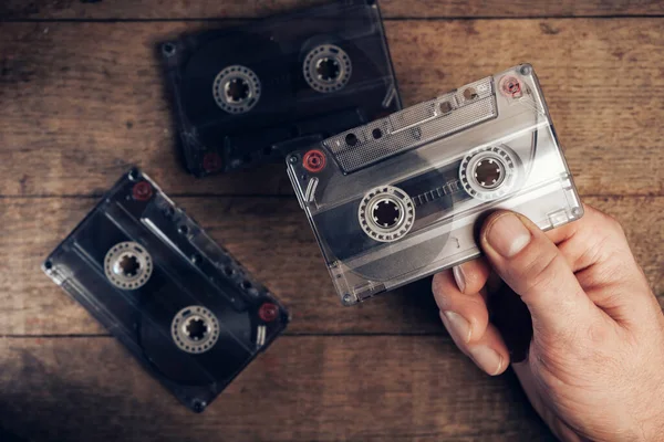 Hand Holding Audio Cassette Tape Brown Old Wooden Table Minimalism — Stock Photo, Image