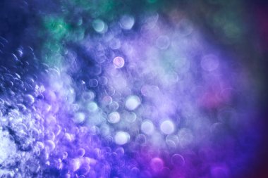 Beautiful multi colored abstract bokeh optical light bokeh on a dark background.	