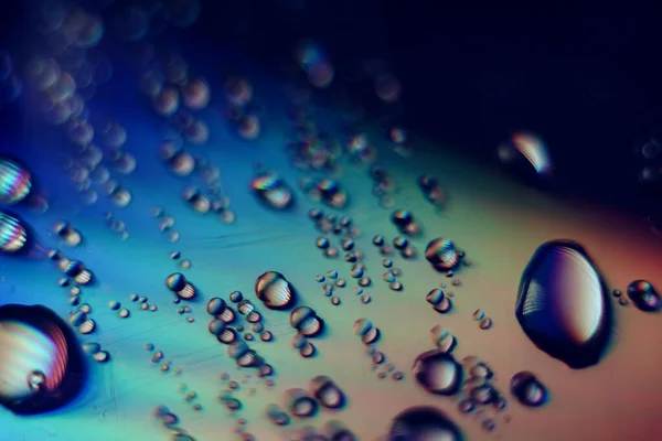 Beautiful multi colored water drop of holographic effect. Background pattern for design. Macro photography view.