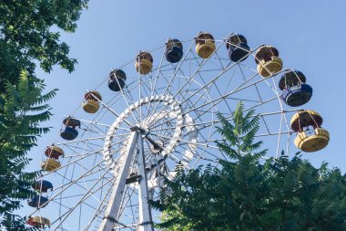Mavi gökyüzü arka planındaki lunaparkın güzel renkli dönme dolabı.