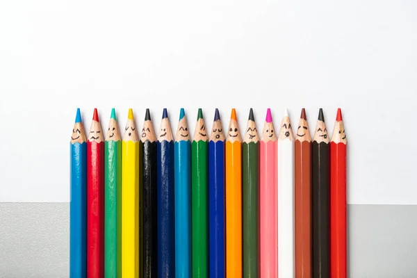 Happy group of persons with colored pencils as social network isolated on white background. closeup, flat-lay