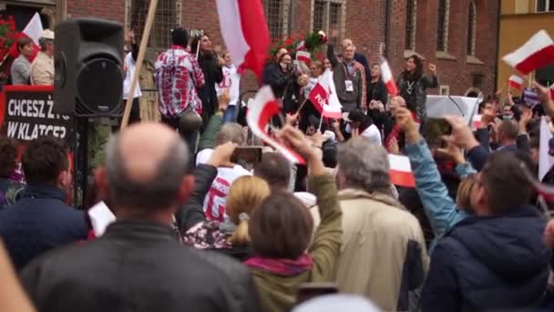 Wroclaw, Polen - 10 oktober 2020 - Ett möte med polska flaggor, motståndare till COVID-19 restriktioner kom till torget i staden. Talare talar från talarstolen — Stockvideo