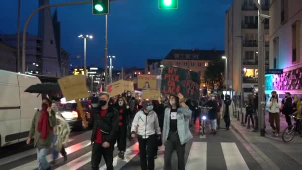 Wroclaw, Poland, 26 october 2020 - Polish womens strike. Huge crowd walking down the street with cars with banners in Polish - polka hasnt died yet, get off my pussy, get the fuck out — Stock video